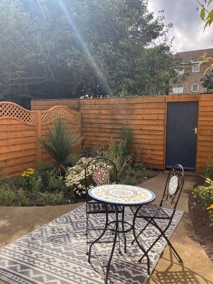 The enclosed courtyard with a bistro table and two chairs